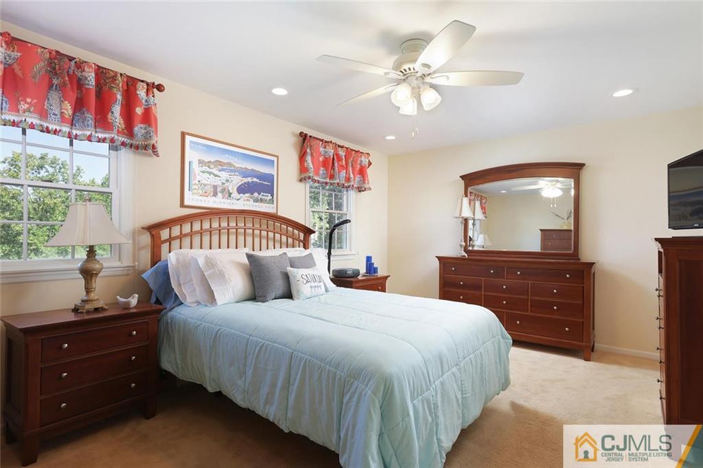 203 Normandy Road Edison, NJ 08820 - Photo 16 of 32 a bedroom with a large bed and a mirror