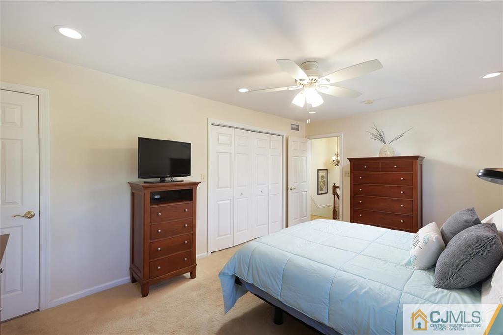 203 Normandy Road Edison, NJ 08820 - Photo 17 of 32 a bedroom with a bed and a television