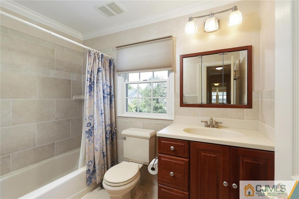 203 Normandy Road Edison, NJ 08820 - Photo 21 of 32 a bathroom with a sink a toilet and shower