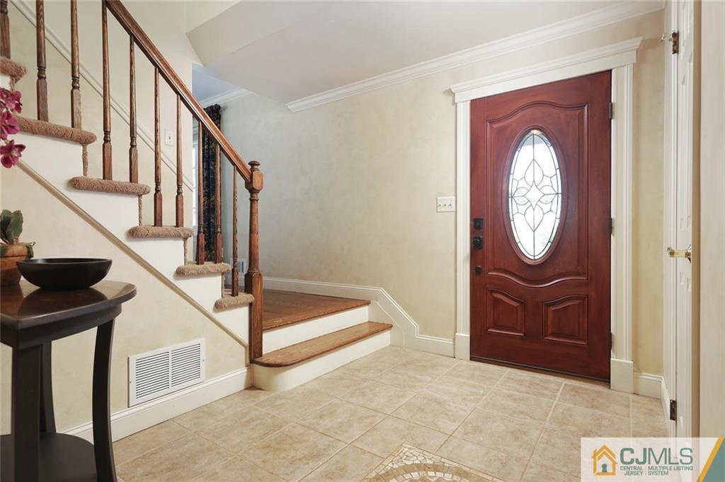 203 Normandy Road Edison, NJ 08820 - Photo 4 of 32 a view of entryway with wooden floor and a front door