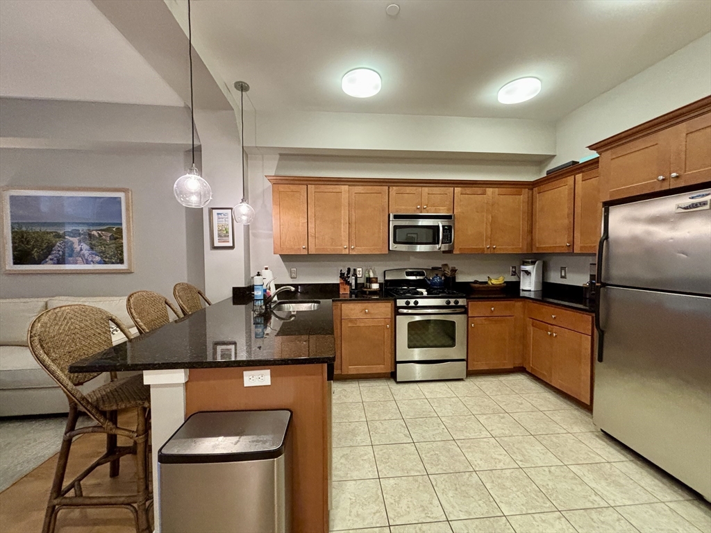 20 Parmenter Street, Unit 403 Boston, MA 02113 - Photo 2 of 16 a kitchen with stainless steel appliances granite countertop a stove a sink a microwave and a refrigerator
