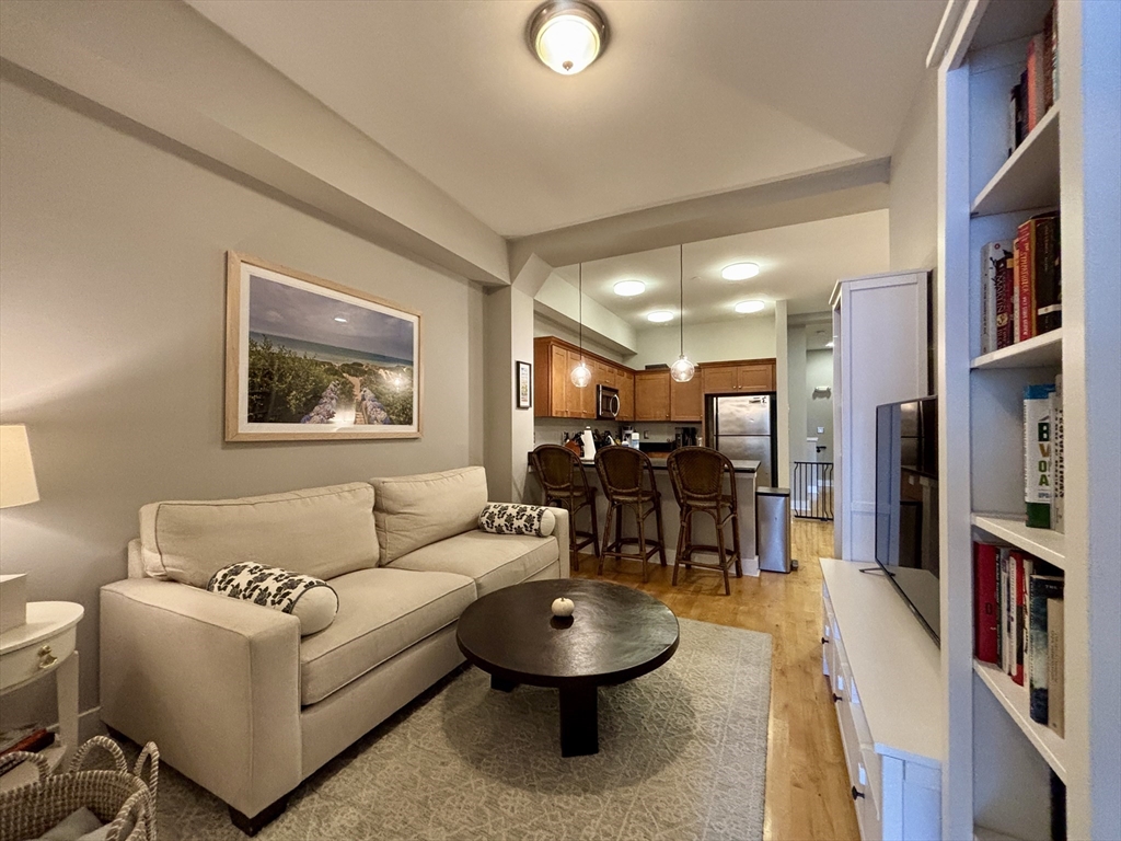 20 Parmenter Street, Unit 403 Boston, MA 02113 - Photo 4 of 16 a living room with furniture and a flat screen tv