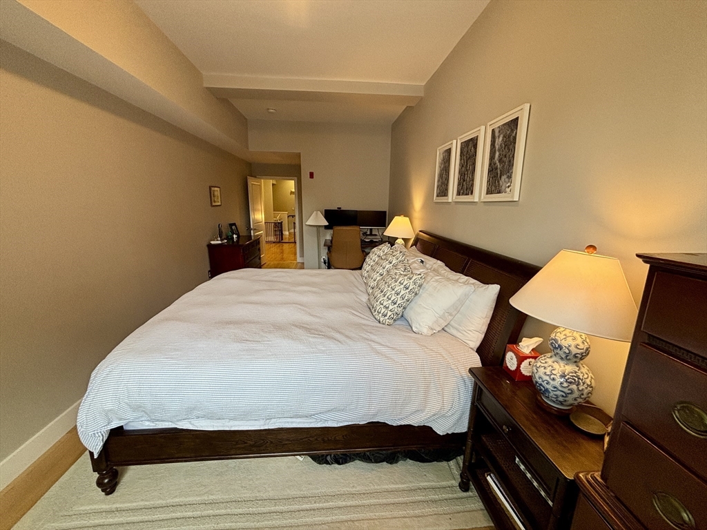 20 Parmenter Street, Unit 403 Boston, MA 02113 - Photo 8 of 16 a bedroom with a bed and wooden floor