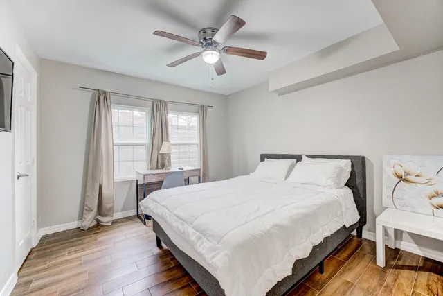 a bedroom with a large bed and a chandelier