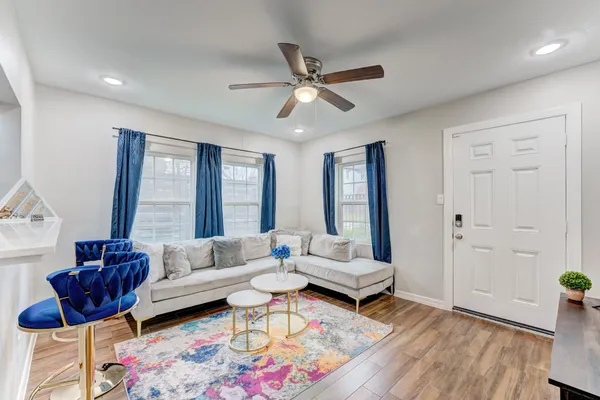 a living room with furniture and wooden floor