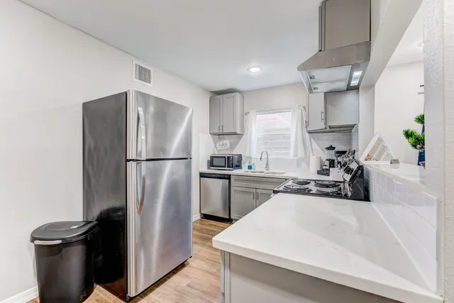a kitchen with a refrigerator and a sink