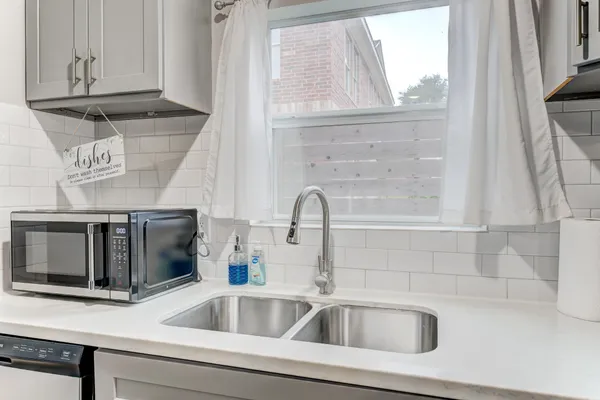 a stove top oven sitting inside of a kitchen