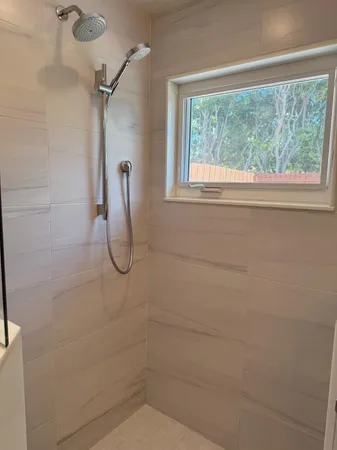 a bathroom with a glass shower door