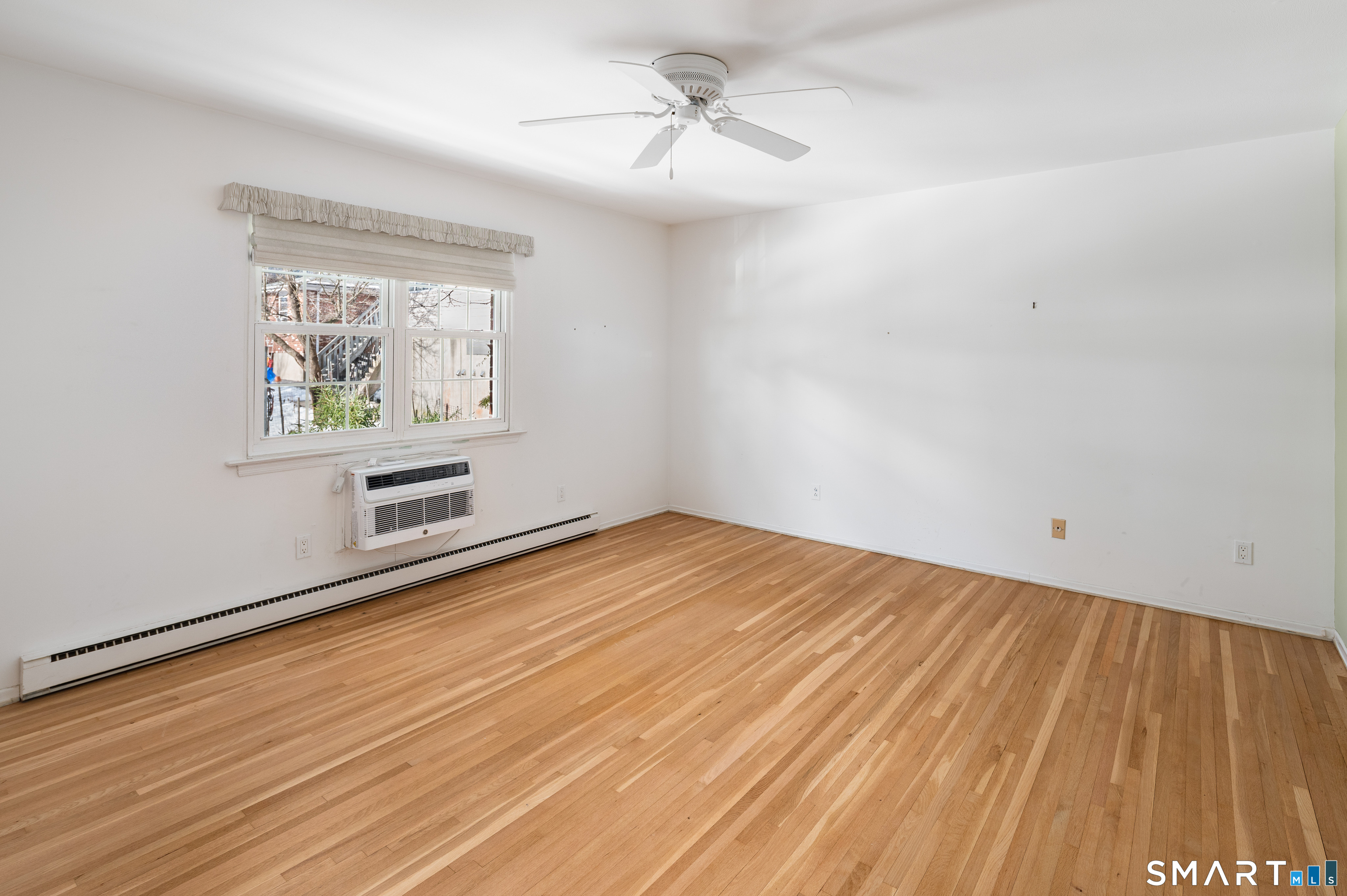 240 Wardwell Street, Unit 26 Stamford, CT 06902 - Photo 16 of 28 wooden floor in an empty room with a window