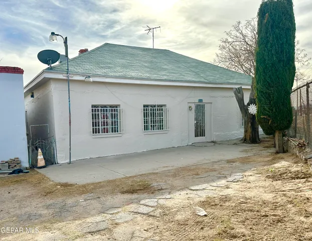 a view of a front door and small yard