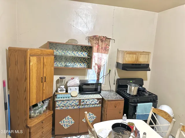 a view of a dining room with furniture and a window