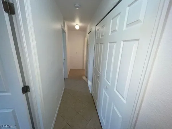 a view of a hallway with a wooden floor