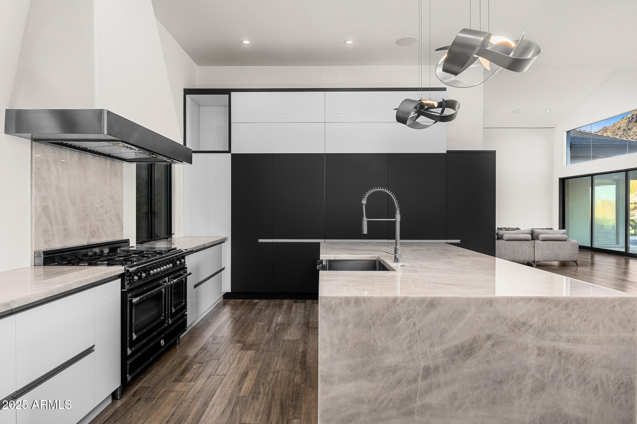 4129 East Sandy Mountain Road Paradise Valley, AZ 85253 - Photo 18 of 76 a kitchen with granite countertop a stove and a wooden floors