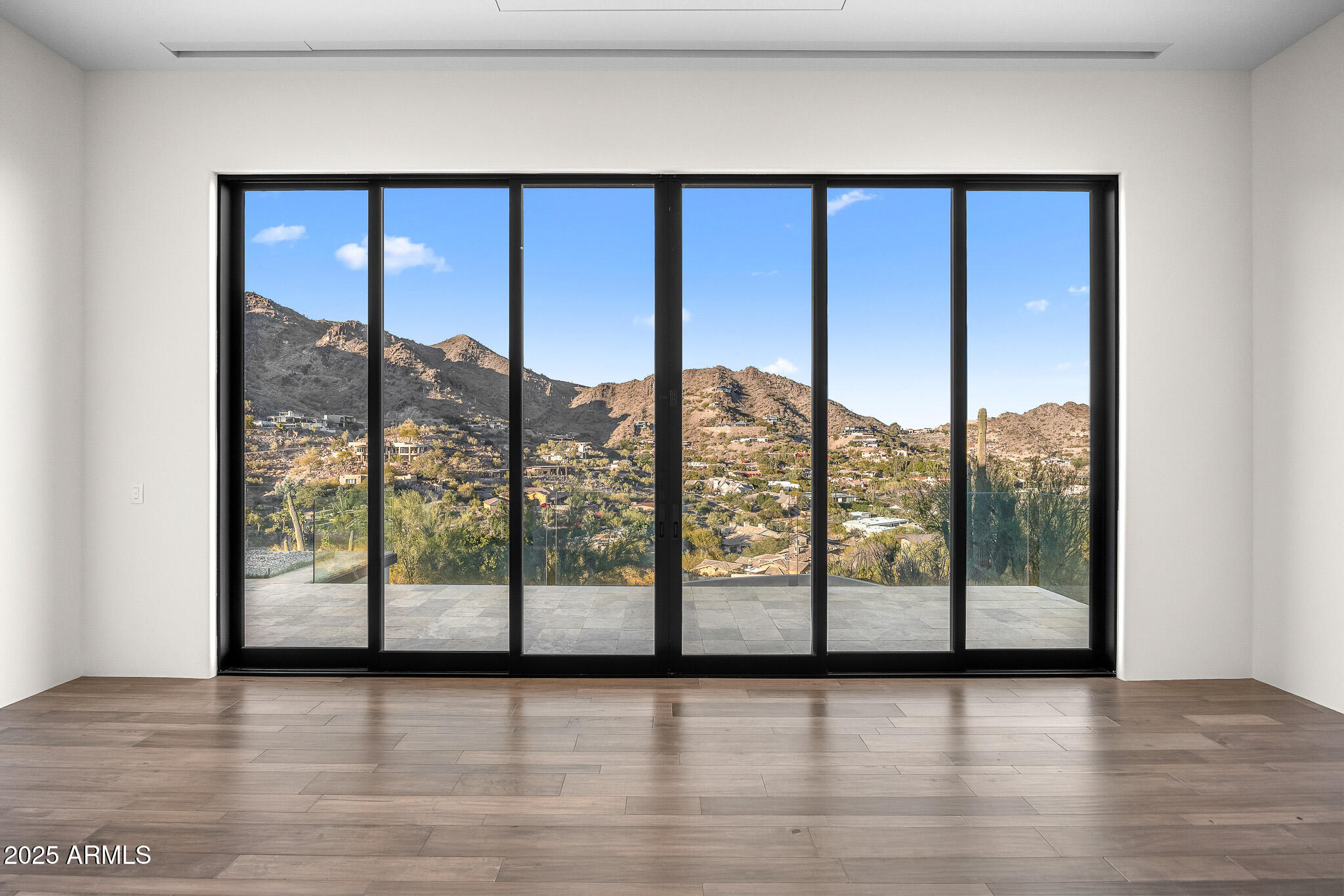 4129 East Sandy Mountain Road Paradise Valley, AZ 85253 - Photo 27 of 76 a view of an empty room with wooden floor and a window