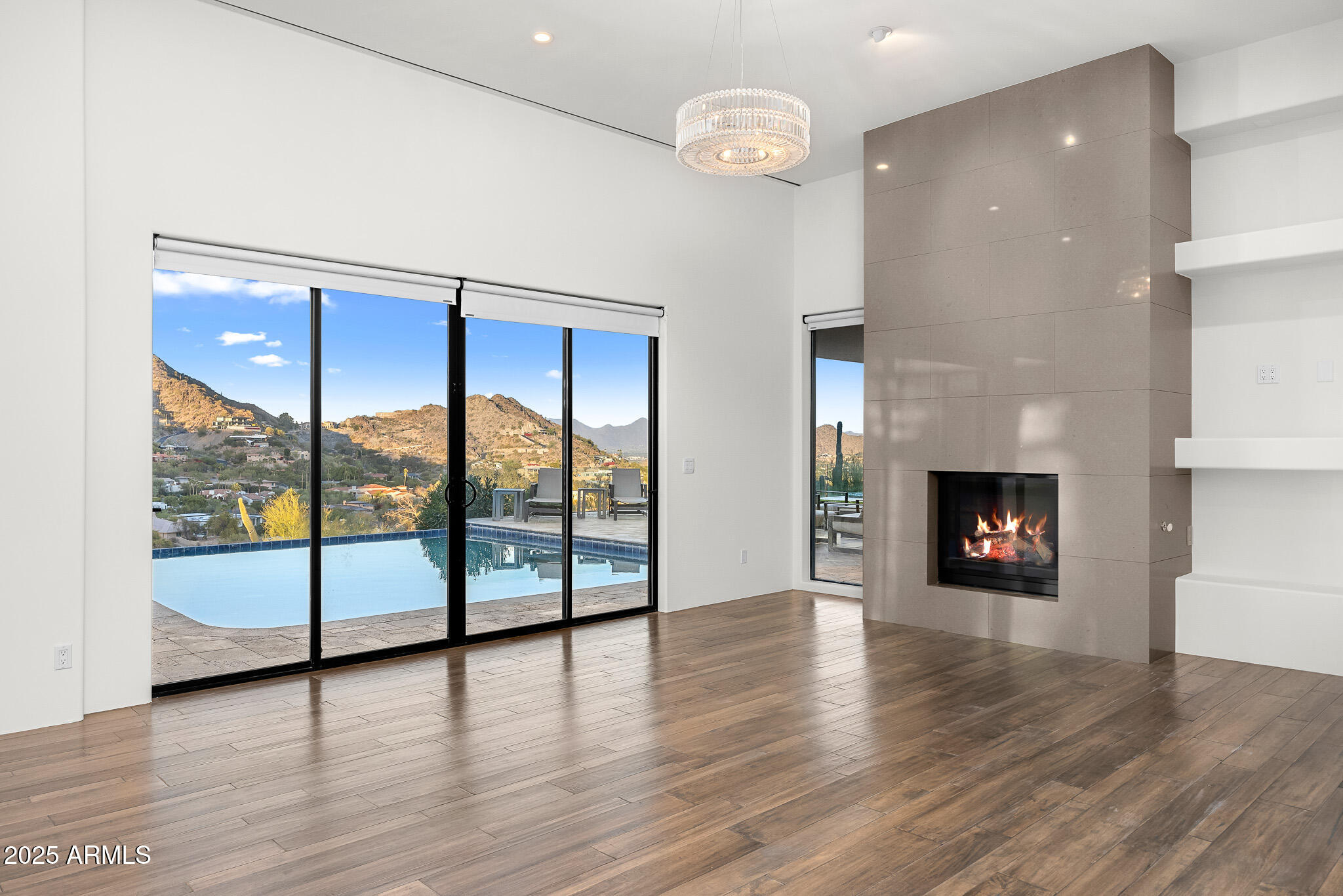 4129 East Sandy Mountain Road Paradise Valley, AZ 85253 - Photo 40 of 76 an empty room with wooden floor and fireplace