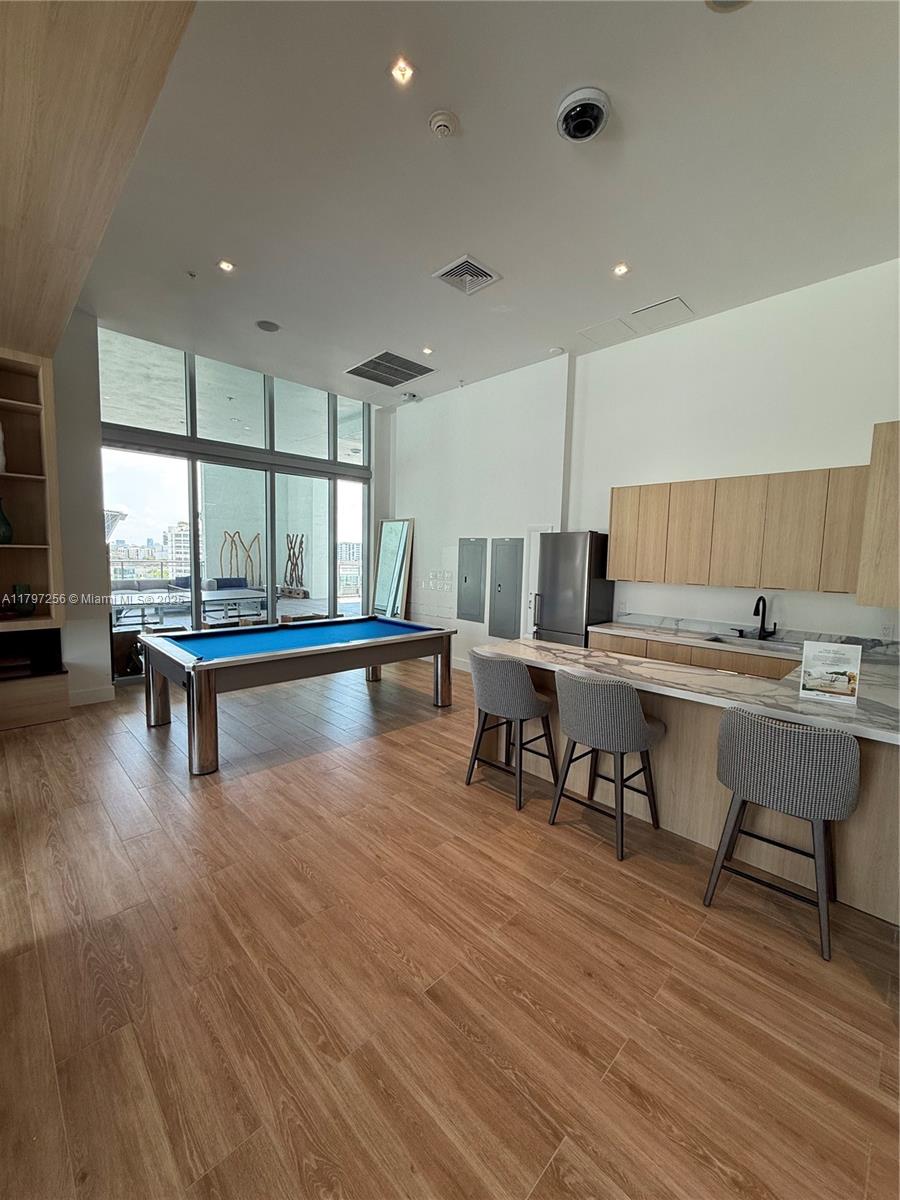 90 Southwest 3rd Street, Unit 3601 Miami, FL 33130 - Photo 36 of 49 a living room with game table a window and chairs