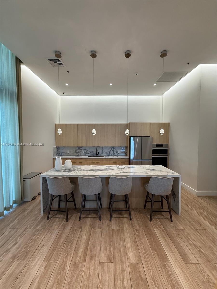 90 Southwest 3rd Street, Unit 3601 Miami, FL 33130 - Photo 45 of 49 a table and chairs in a room with wooden floor