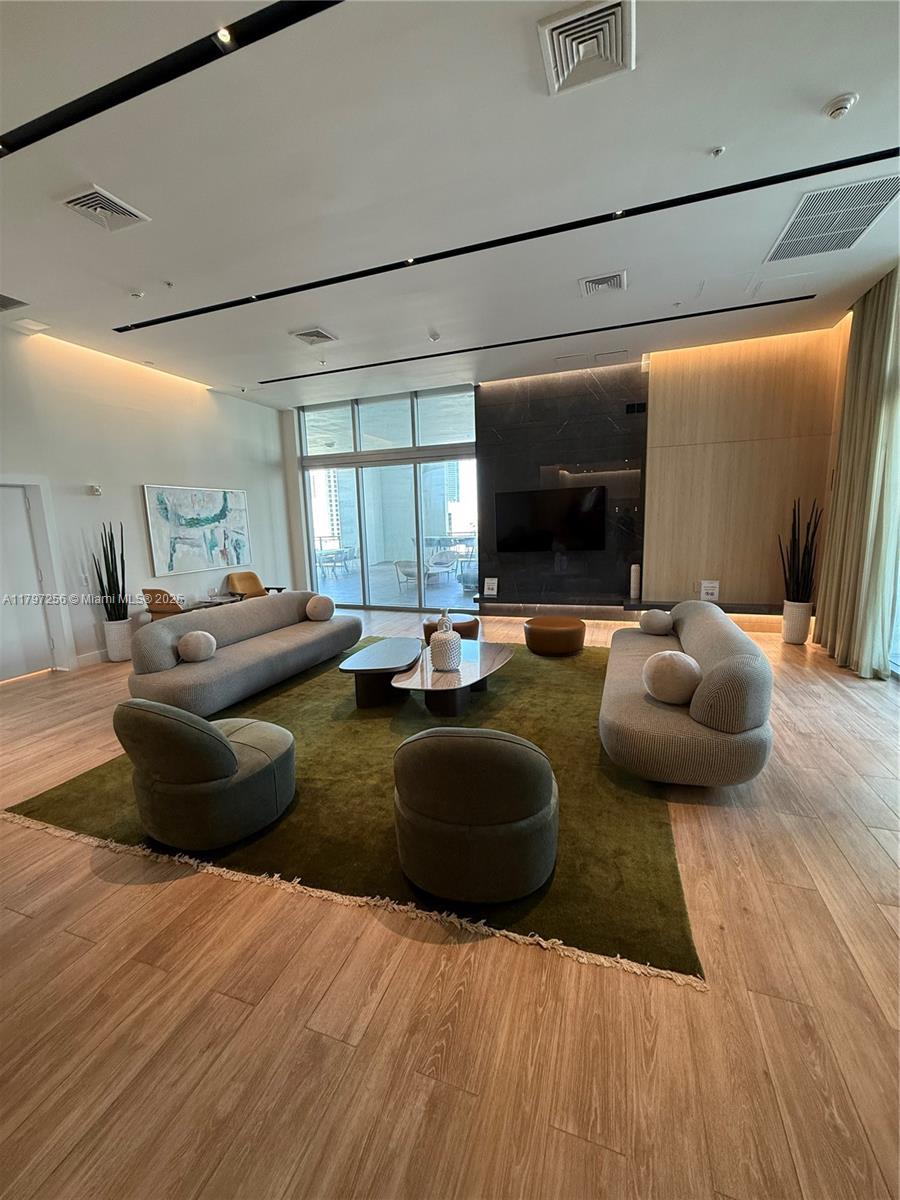 90 Southwest 3rd Street, Unit 3601 Miami, FL 33130 - Photo 46 of 49 a living room with furniture and a flat screen tv