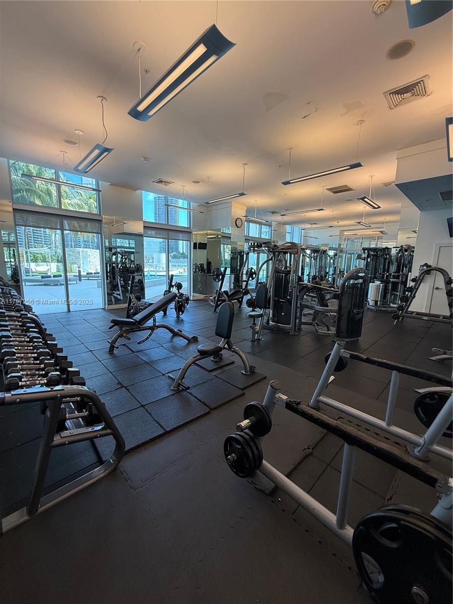 90 Southwest 3rd Street, Unit 3601 Miami, FL 33130 - Photo 5 of 49 a room with gym equipment and a large window