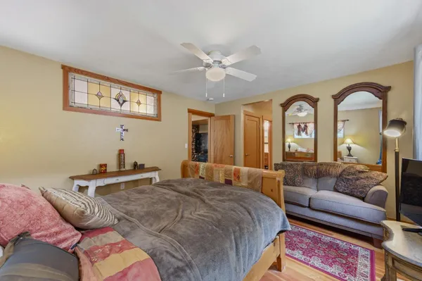 a bedroom with a bed and ceiling fan
