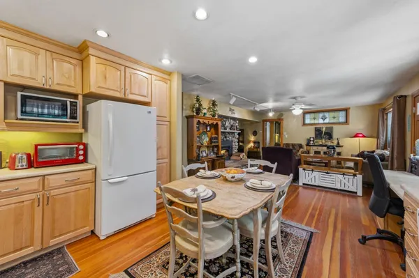 a kitchen with stainless steel appliances granite countertop a refrigerator a stove a sink dishwasher and a dining table with garden view