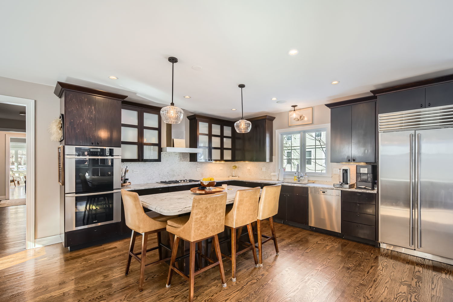 83 North Cowley Road Riverside, IL 60546 - Photo 8 of 36 a kitchen with stainless steel appliances granite countertop a kitchen island a table and chairs in it