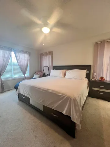 a bedroom with a bed and a night stand