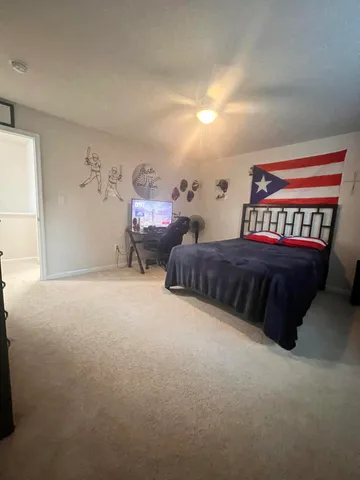 a bedroom with bed and a chandelier