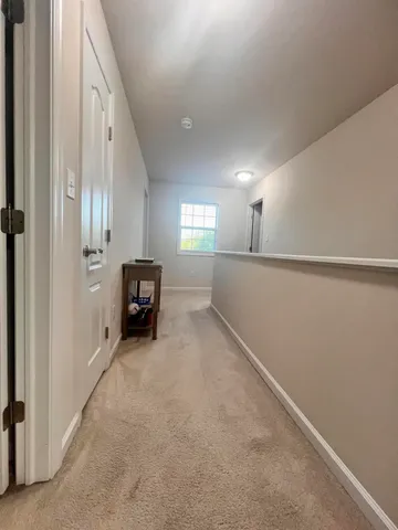 a view of a hallway with staircase