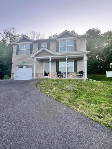 a view of a house with a yard and plants