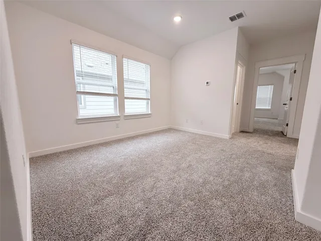 an empty room with a window and a fireplace