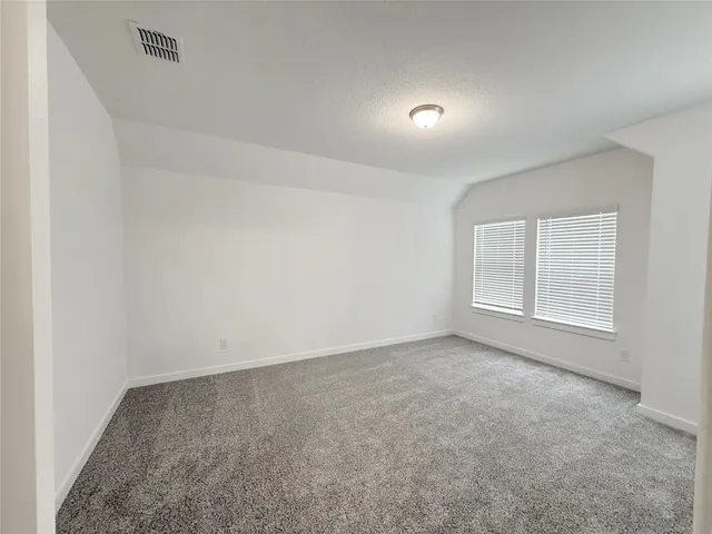 an empty room with a empty space and windows