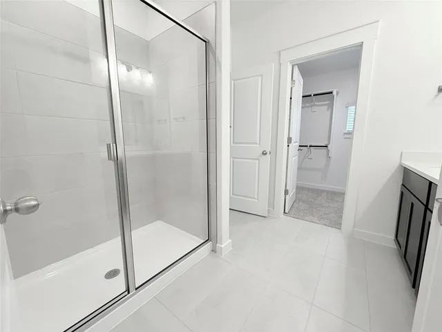 a bathroom with a glass door shower