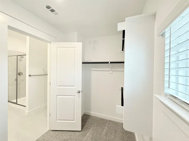 a view of walk in closet with window