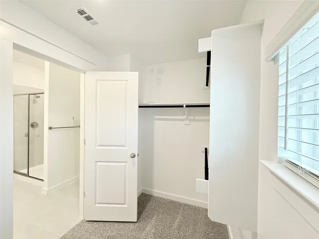 a view of walk in closet with window
