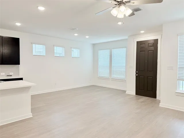 a view of an empty room with a cabinet