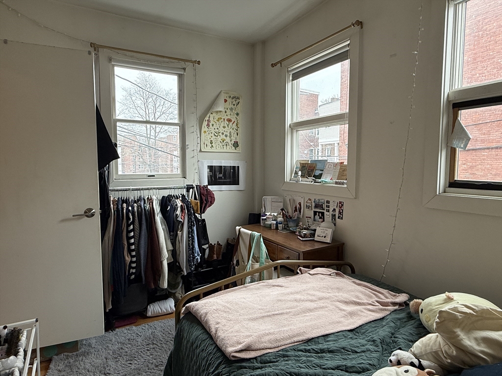 1871 Beacon Street, Unit 4 Brookline, MA 02445 - Photo 9 of 14 a bed sitting in a bedroom next to a window