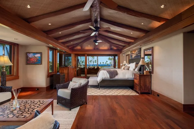 a bedroom with furniture and a large window