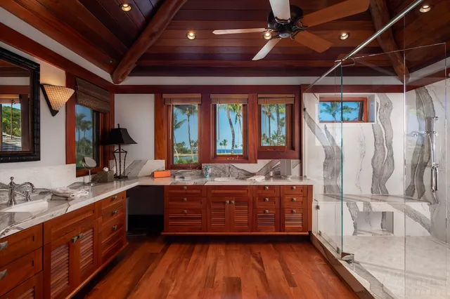 a large kitchen with wooden floors and sink