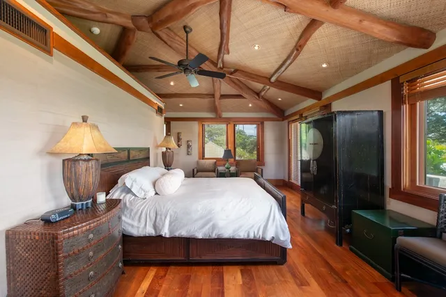 a bedroom with a bed mirror and window