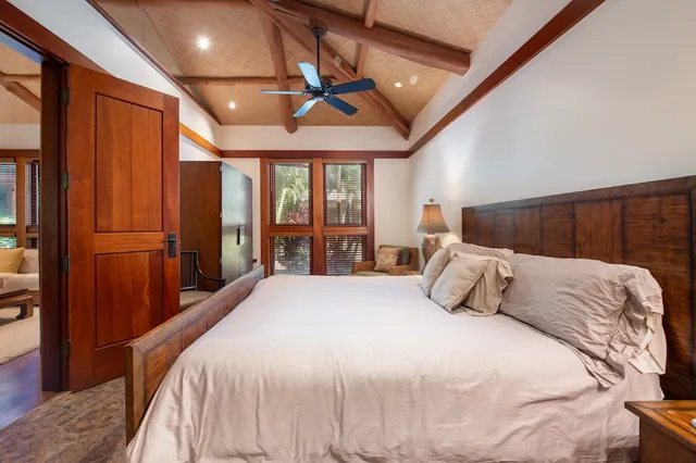 a bedroom with a large bed and a large window