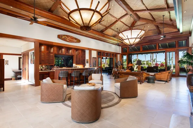 a living room with furniture and a ceiling fan