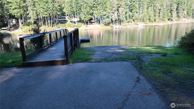 a sign broad in front of the red tree