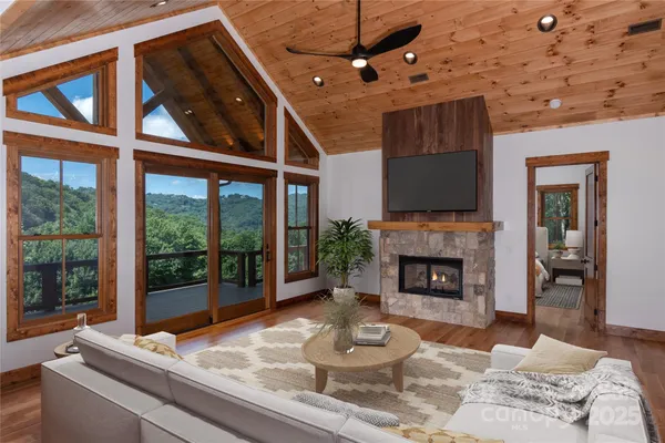 a living room with furniture a fireplace and a floor to ceiling window