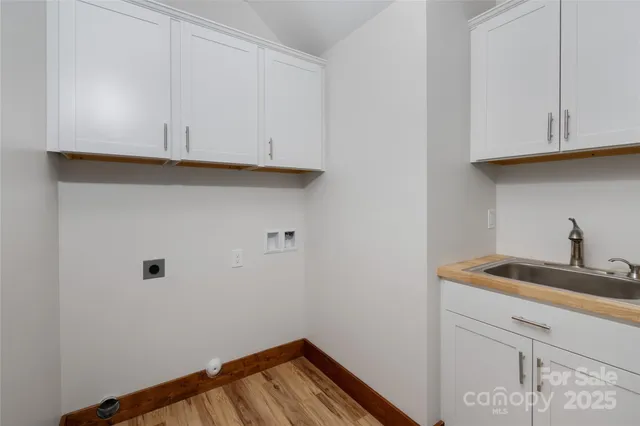 a view of a kitchen with white cabinets