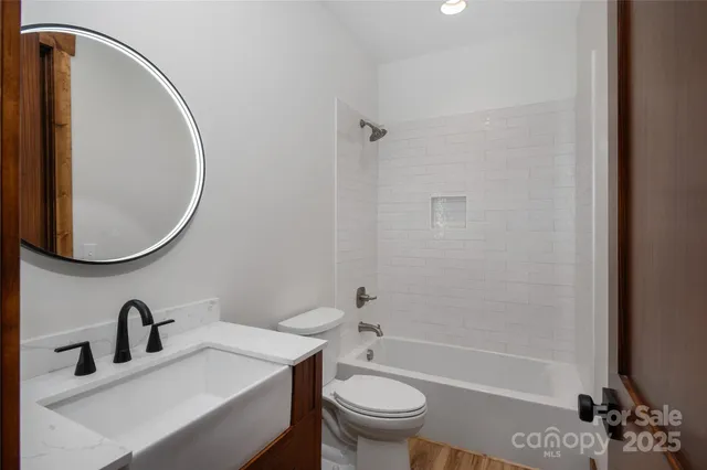 a bathroom with a sink toilet and a mirror