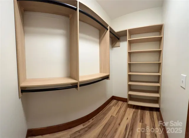 a view of walk in closet with empty racks