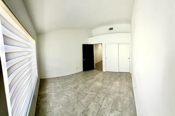 a view of an empty room and a hallway