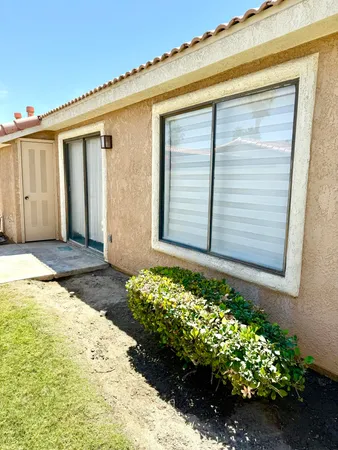 a view of an house with backyard of house