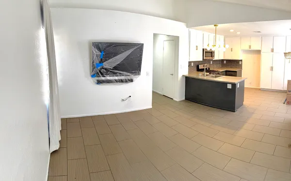 a view of a kitchen with stainless steel appliances granite countertop a sink and a refrigerator